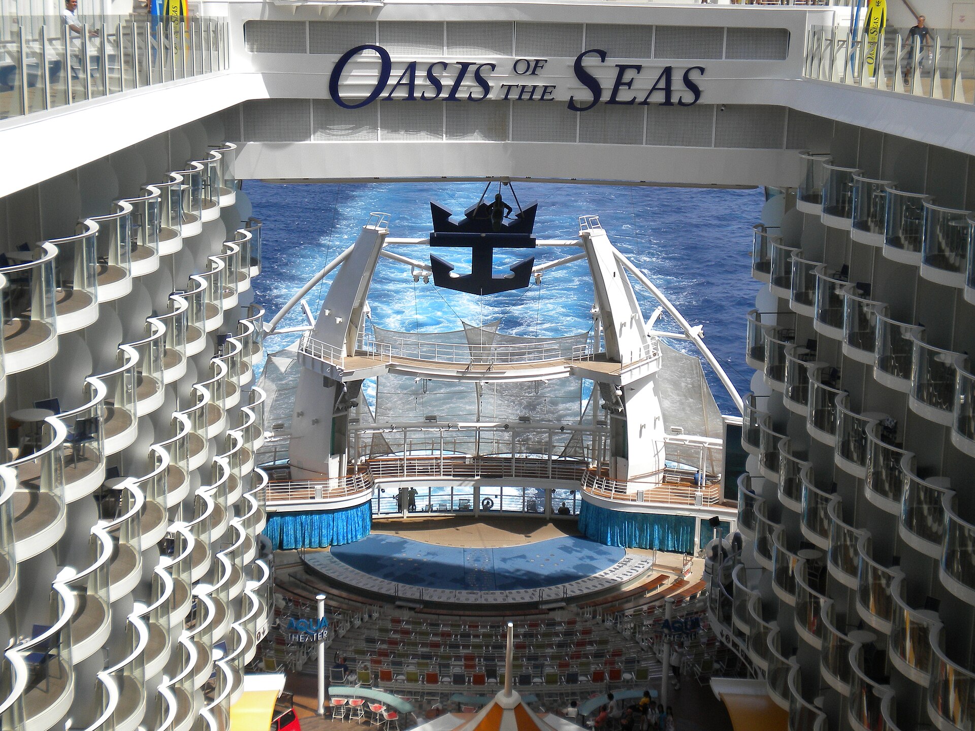 The AquaTheater amphitheatre at the stern of Oasis of the Seas, framed by rows of balconies with the blue ocean behind