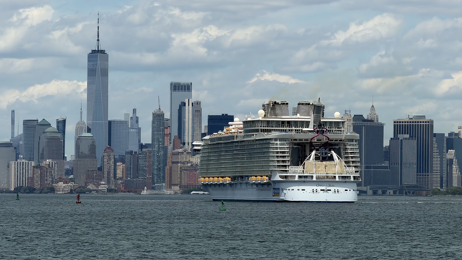Oasis of the Seas sailing through New York Harbor with the Lower Manhattan skyline and One World Trade Center behind it