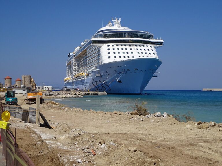 Royal Caribbean's Odyssey of the Seas moored in Rhodes, Greece, beside turquoise water under a clear blue sky