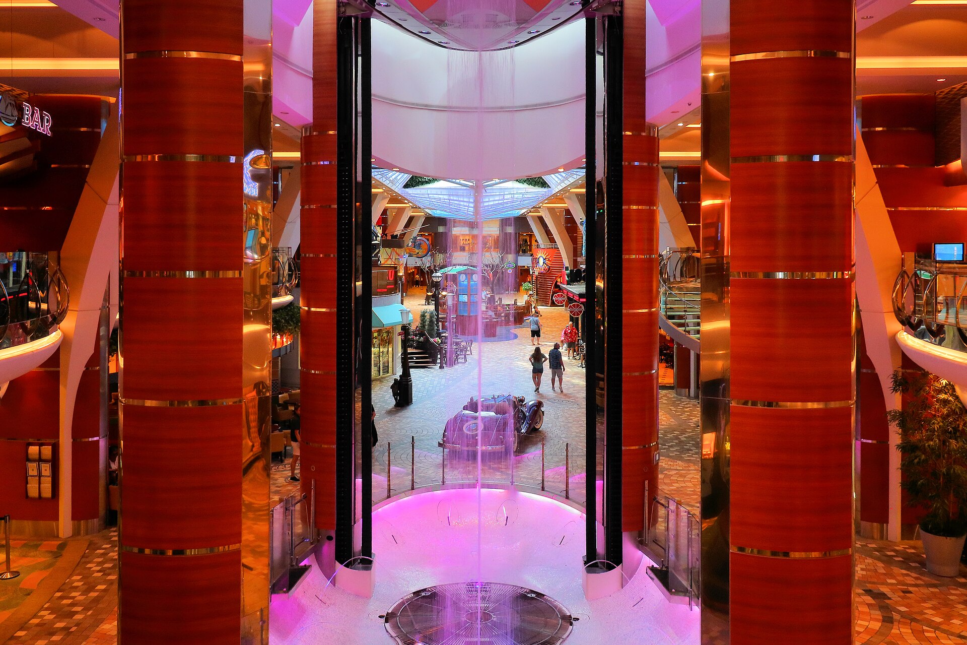 The pink-lit Royal Promenade shopping street inside Allure of the Seas
