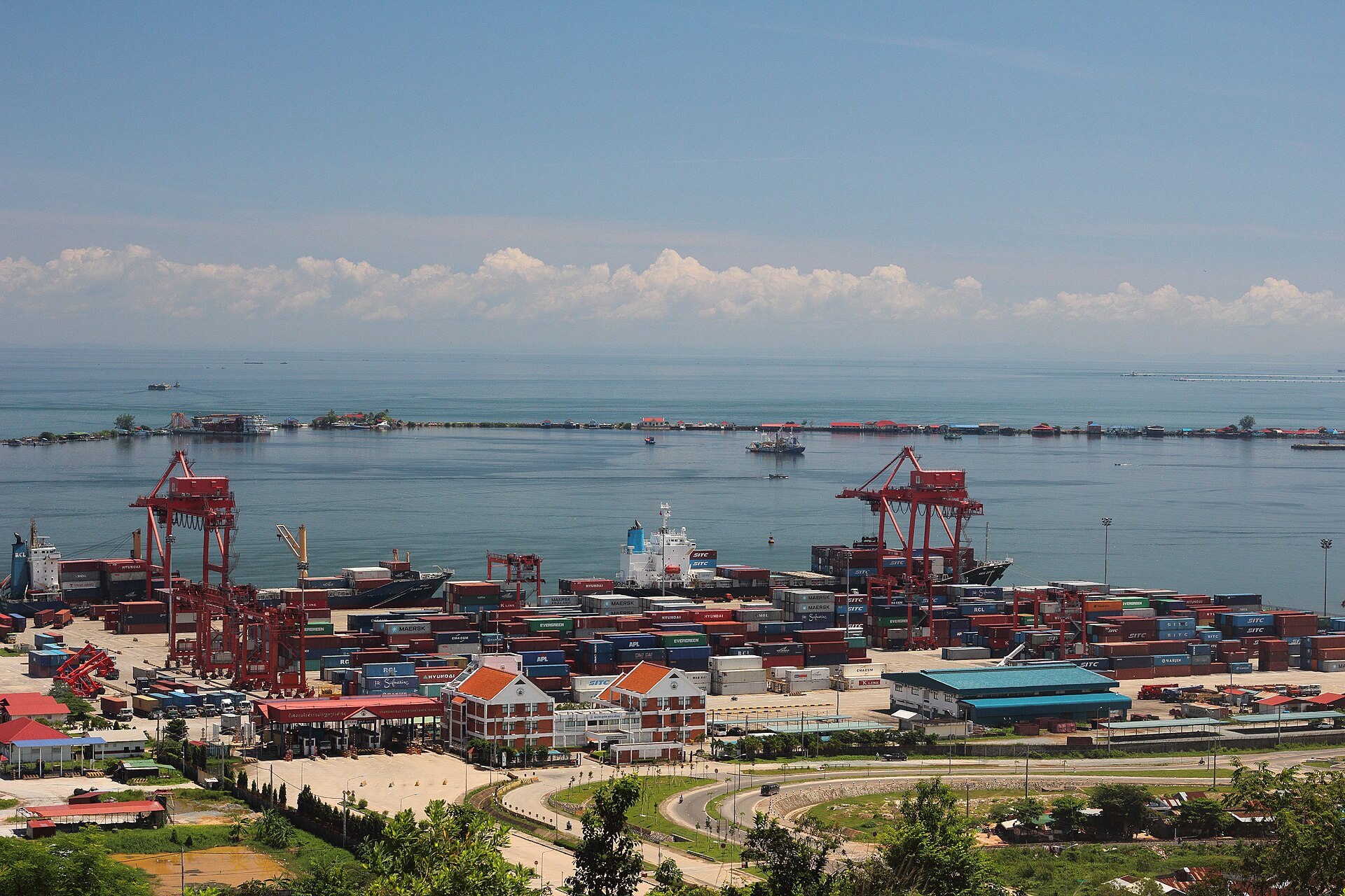 Sihanoukville Autonomous Port in Cambodia with red cranes, containers and the Gulf of Thailand