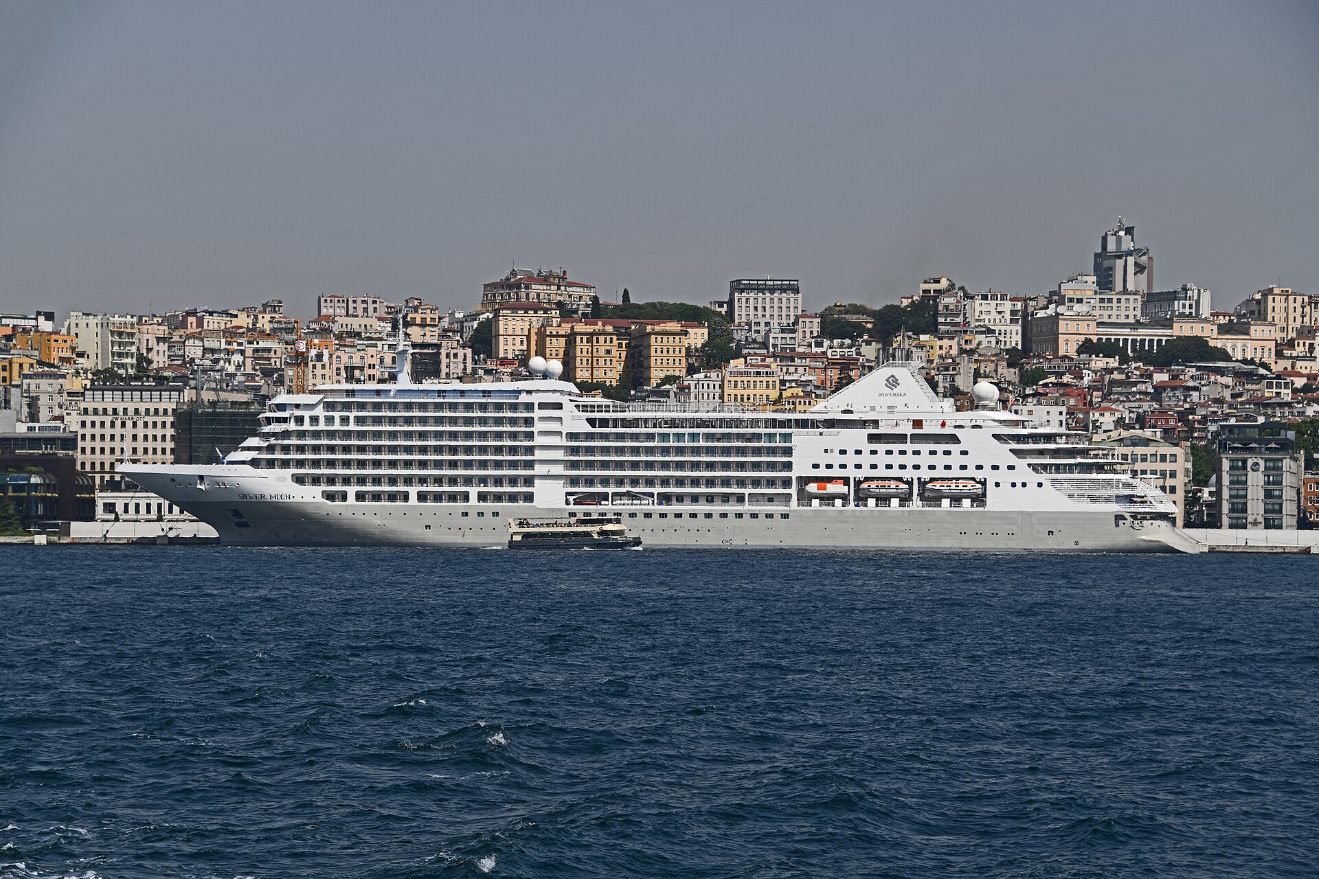 Silver Moon cruise ship moored at Galataport in Istanbul across the blue water of the Bosphorus