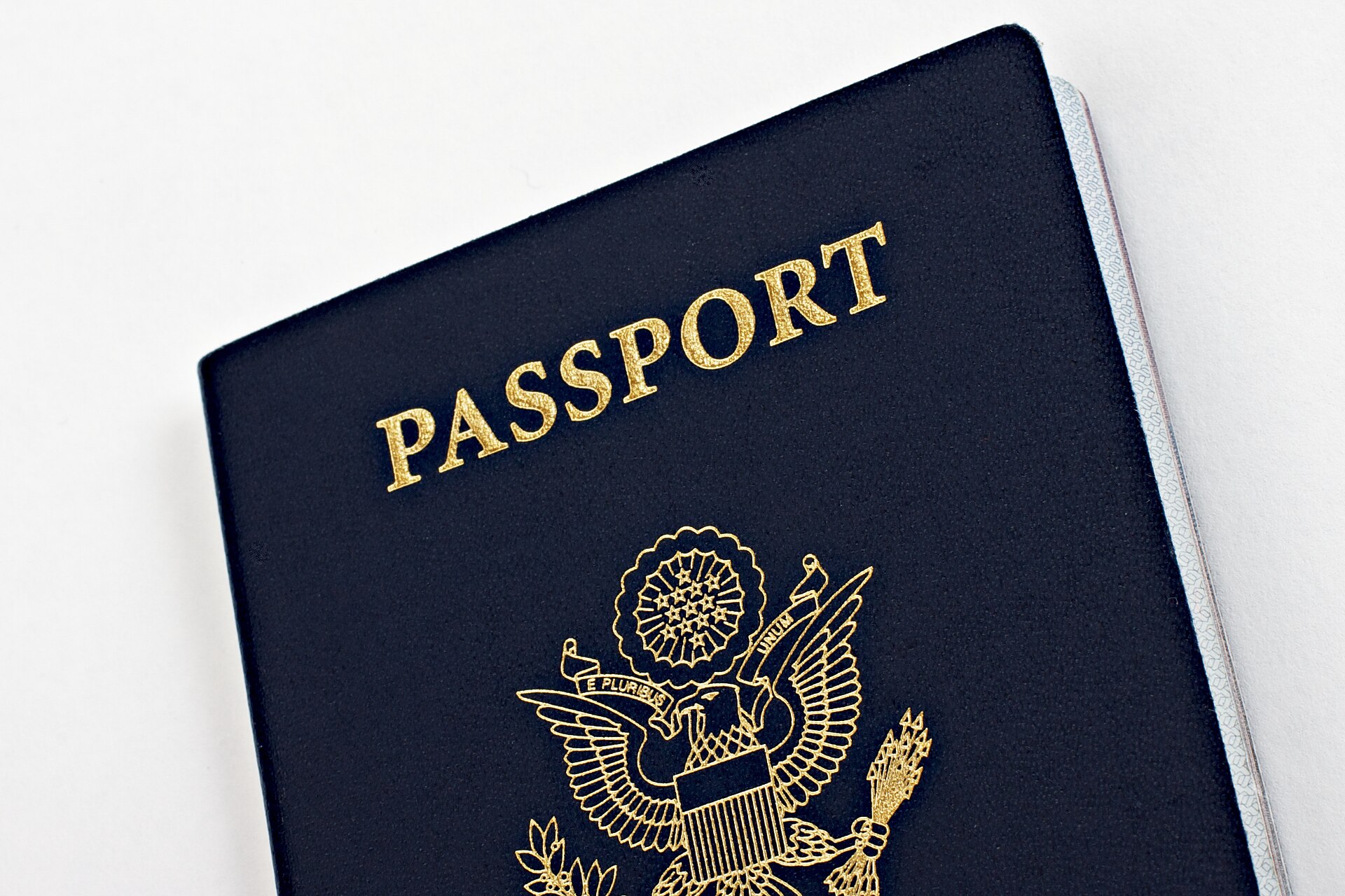 Navy blue United States passport book with gold lettering and the eagle seal on the cover
